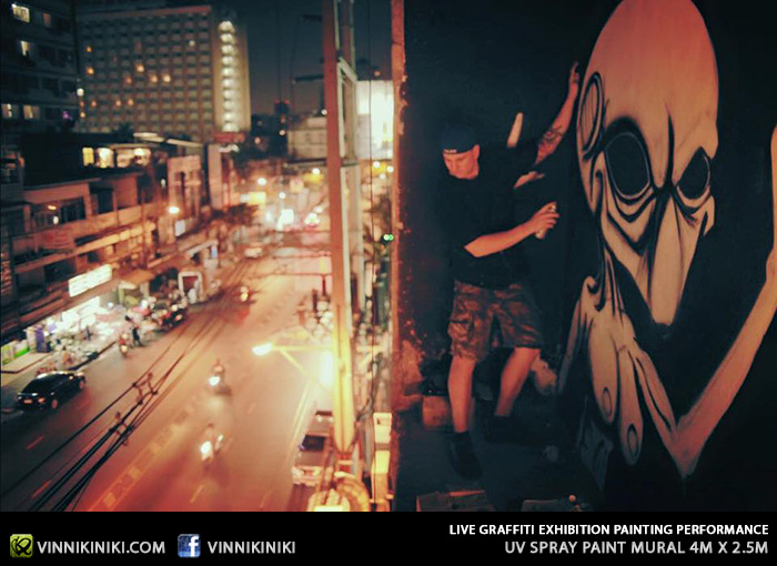Graffiti artists painting on a high ledge Bangkok