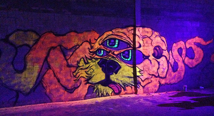 black light art mural of an alien hybrid creature