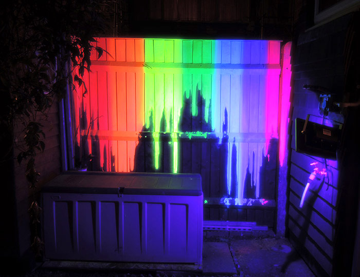 Black light neon dripping rainbow mural