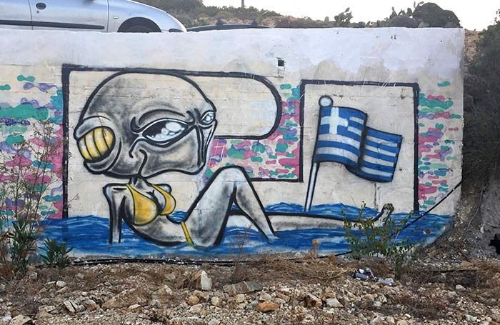 Sunbathing alien beach babe in Greece