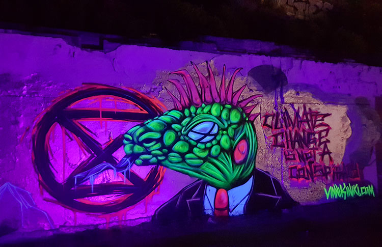 UV black light street art extinction rebellion lizard Brighton