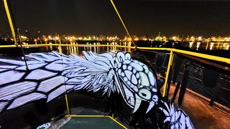 ouroboros serpent cellograff at night panoramic river view art installation