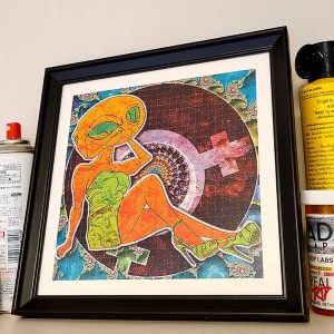 photo of a framed alien themed lsd blotter art gift featuring fractal psychedelic design