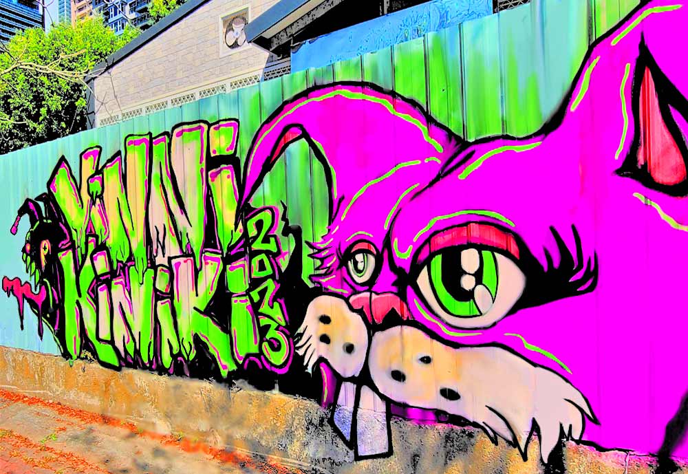 Vibrant pink and purple rabbit street art mural painted on exterior wall in Kaohsiung City, Taiwan by ViNNi KiNiKi