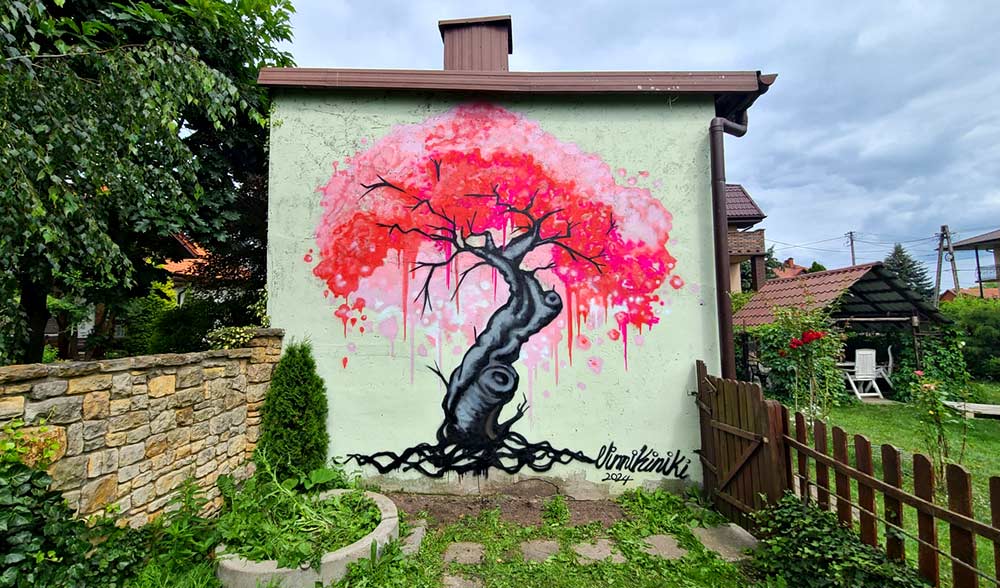House sized cherry blossom sakura street art graffiti mural on exterior of building painted in Poland