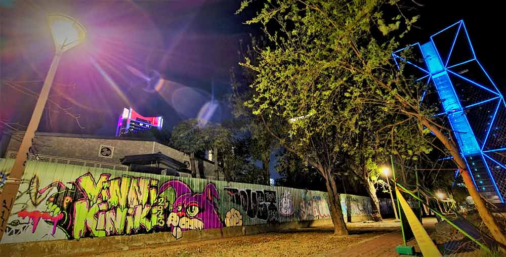 Large pink bunny character and lettering graffiti mural by ViNNi KiNiKi on metal fencing in Kaohsiung, Taiwan
