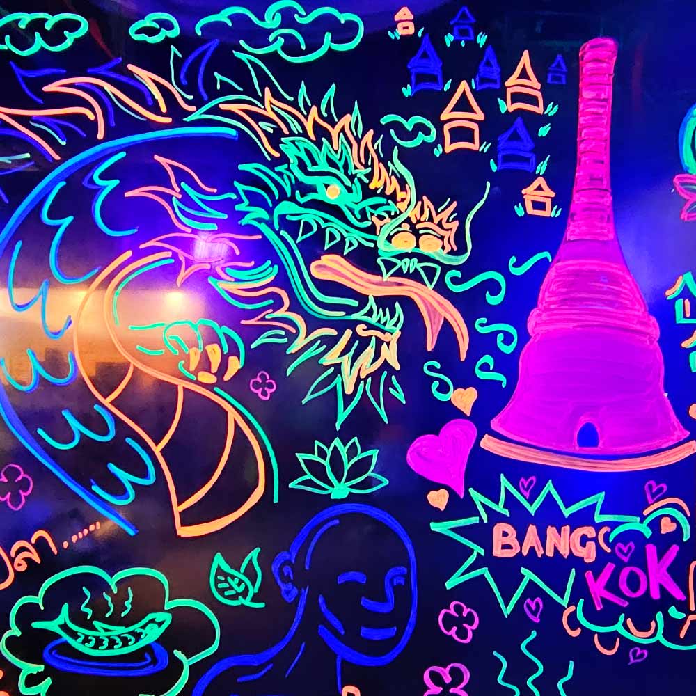 black light reactive inks and paint pens on glass entrance to restaurant at My Thai Manchester by artist Vinni Kiniki 