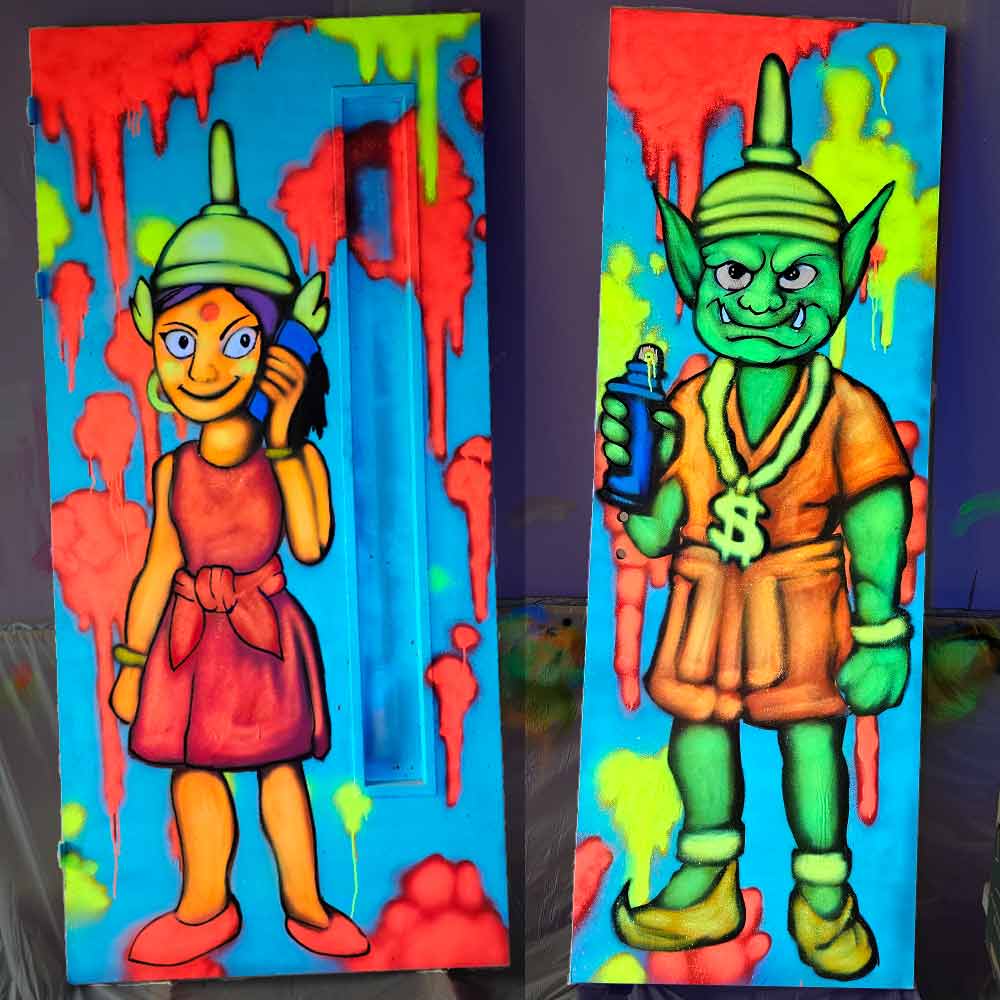 UV reactive graffiti pop art murals on toilet doors at My Thai restaurant in Manchester Piccadilly, featuring a stylised Thai woman on mobile phone for the ladies’ door and a humanised Yaaksha giant with spray can and hip hop bling for the gents’ door, painted by artist ViNNi KiNiKi