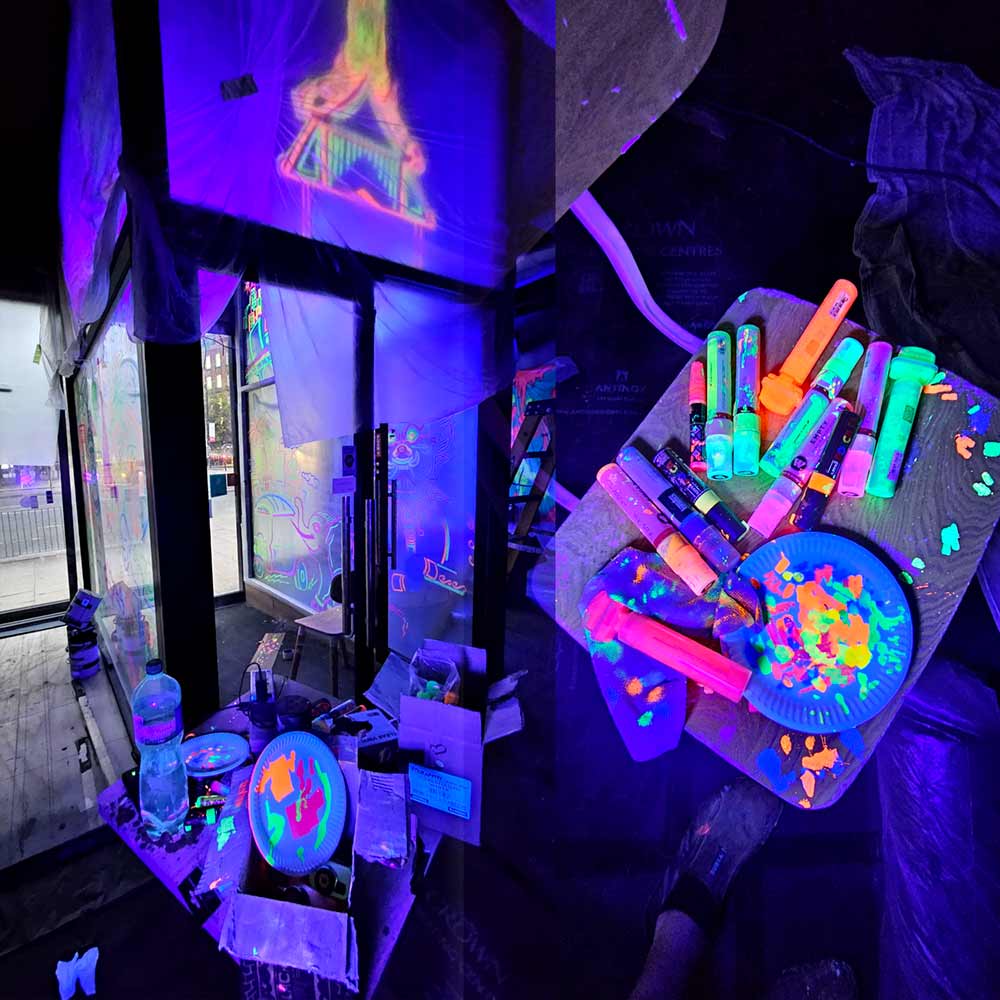 Painting a glass entrance using black light reactive inks and paint pens 