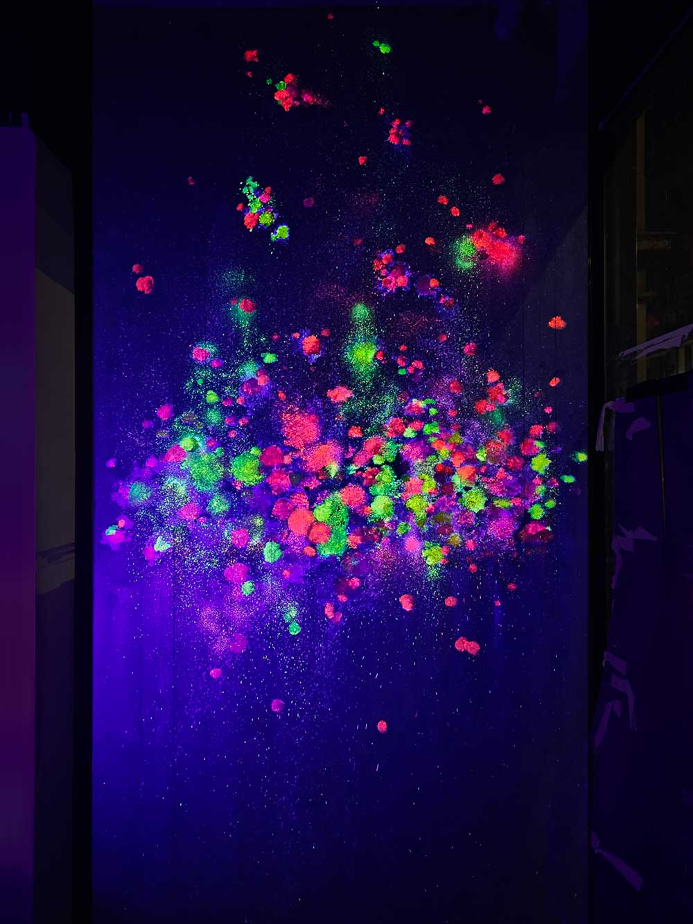 Black light art on dark-stained timber wall at My Thai restaurant in Manchester Piccadilly, painted by artist ViNNi KiNiKi