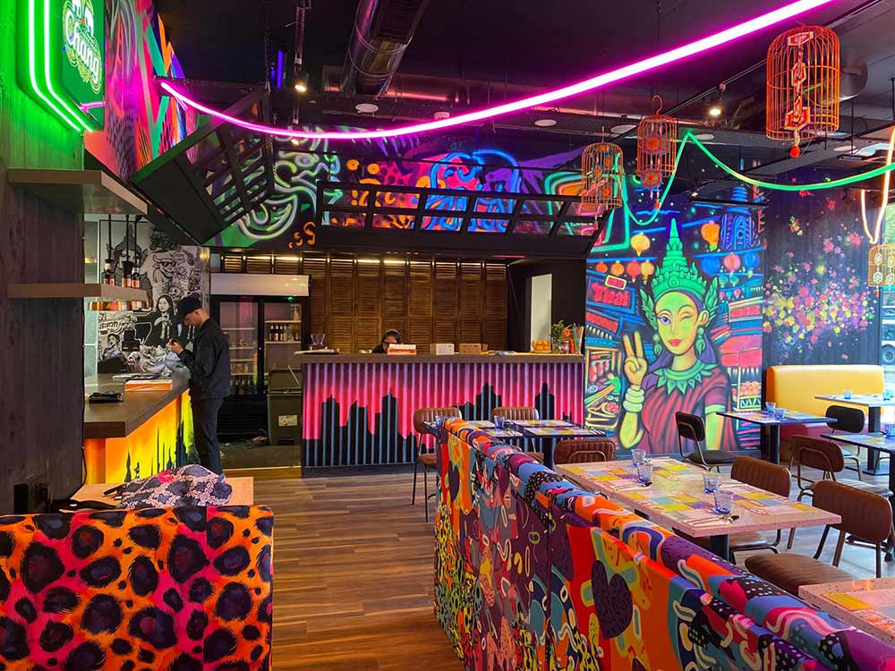 Pop art and black light graffiti mural interior at My Thai Restaurant Manchester Piccadilly