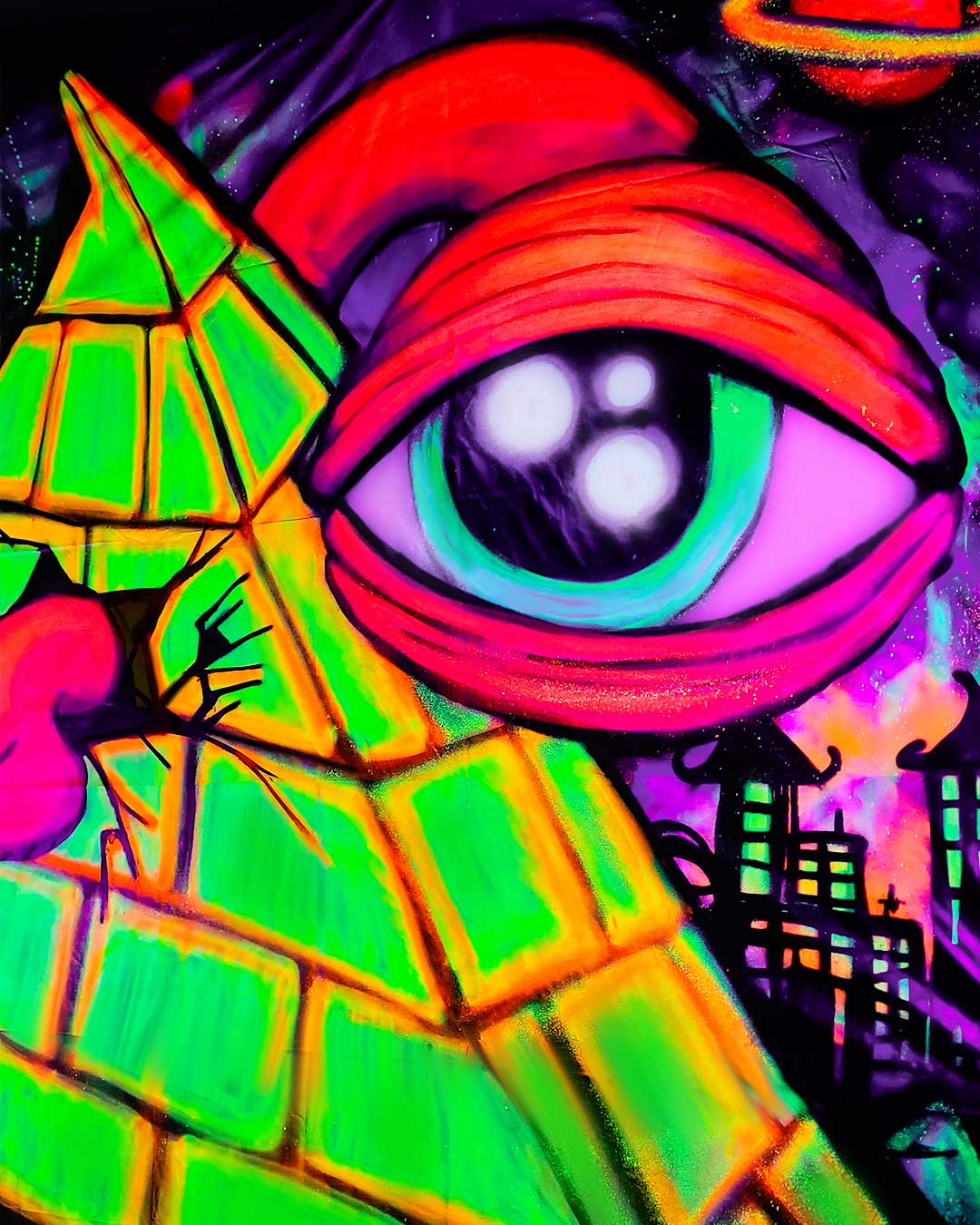 Close-up detail of a vibrant fluorescent pink all-seeing eye and green brick pyramid painted with blacklight spray paint by ViNNi KiNiKi.